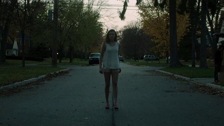 A teenager wanders an empty road