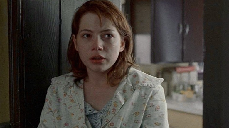 Redhead Michelle Williams standing in doorway in Brokeback Mountain