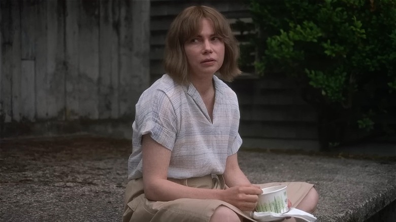 Michelle Williams with short brown hair looking to the side