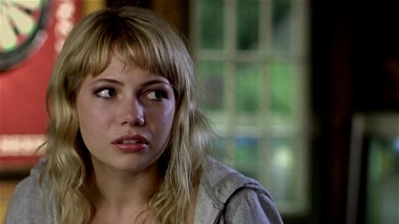 Michelle Williams with bangs looking to the side in The Station Agent