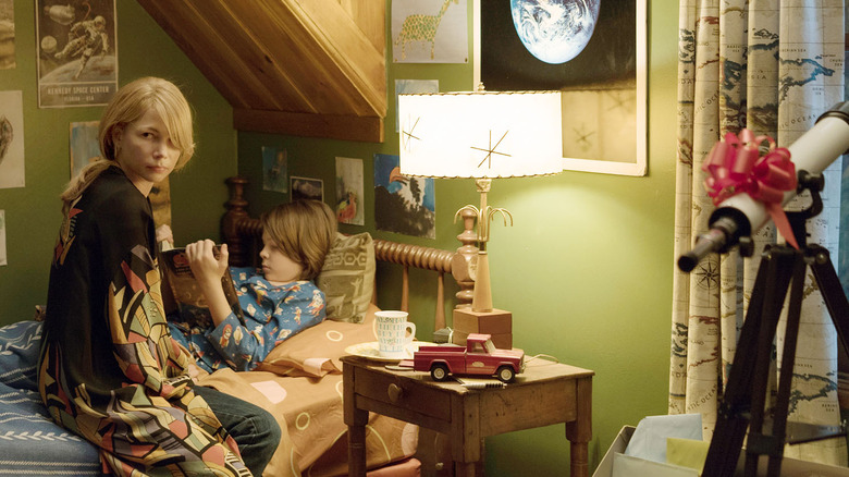 Michelle Williams sitting with boy in bedroom in Wonderstruck