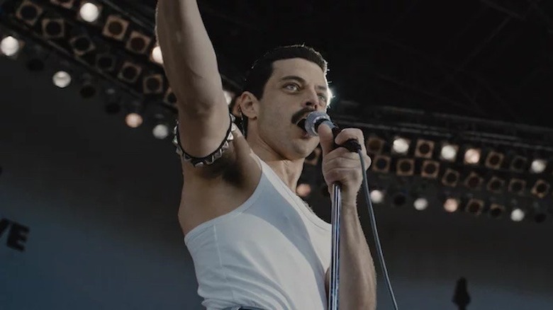 Rami Malek performing on stage as Freddie Mercury 
