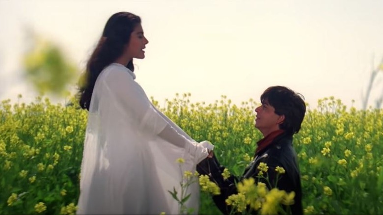 Kajol and Shah Rukh Khan kneeling in "Dilwale Dulhania Le Jayenge"