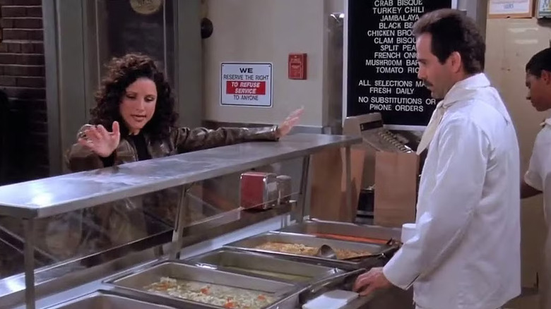 Louis-Dreyfus as Elaine ordering from Larry Thomas as the Soup Nazi in Seinfeld