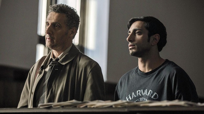 Riz Ahmed and John Tutorro listen in a meeting