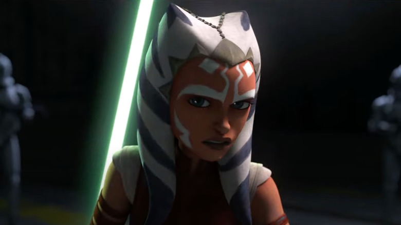 Ahsoka standing in darkness with lightsaber