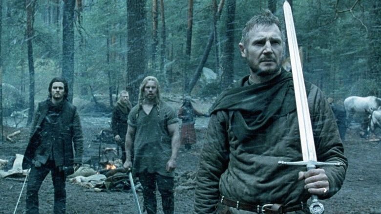 Godfrey (Liam Neeson) clutches his sword as Balian (Orlando Bloom) looks on in Kingdom of Heaven