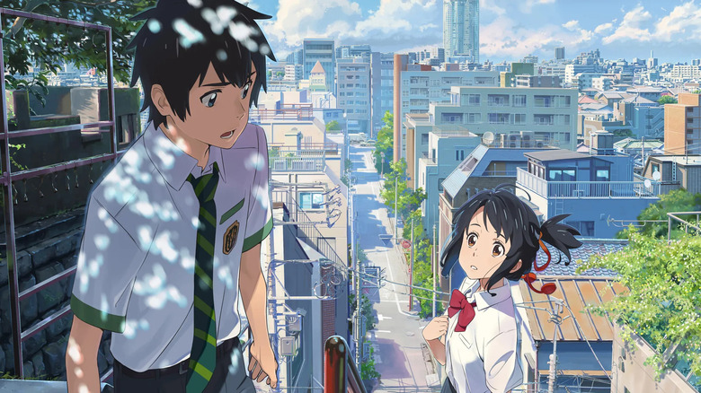 Taki passes Mitsuha on city stairs in Your Name