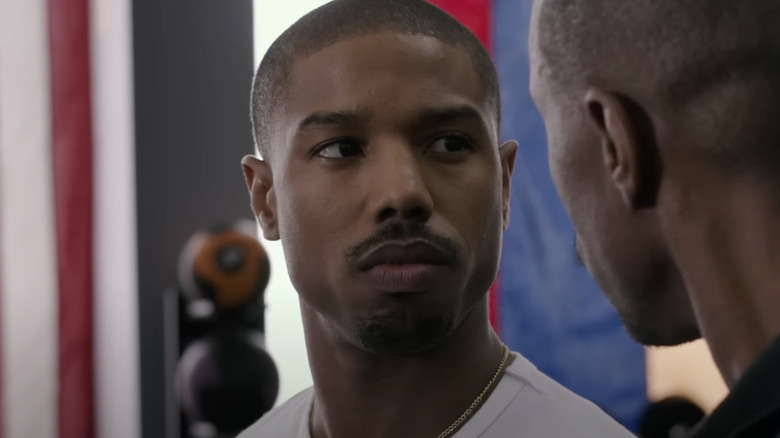 Michael B. Jordan as Adonis Creed looks at a trainer in Creed