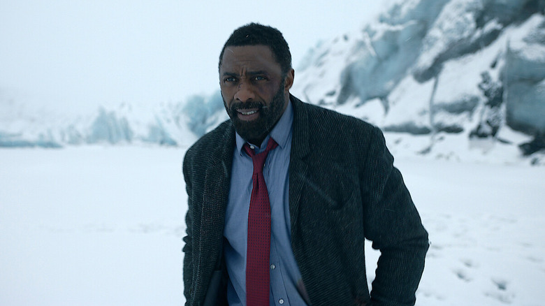 Idris Elba as Luther, standing in a snowy landscape in the series Luther