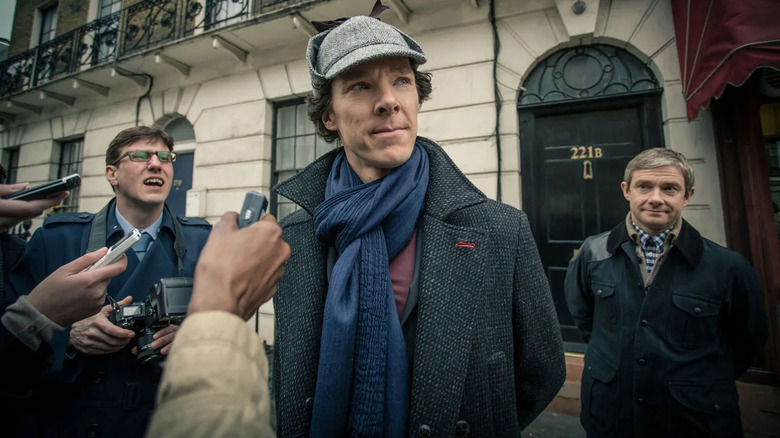 Benedict Cumberbatch and Martin Freeman as Sherlock Holmes and John Watson, confronting reporters in Sherlock