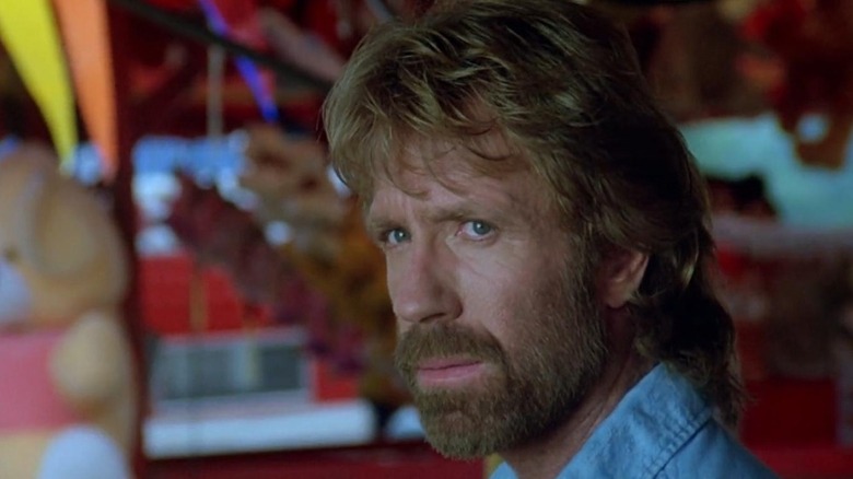 Chuck Norris as Hunter looking on in Invasion USA