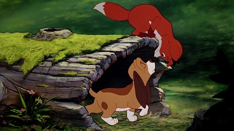 a puppy and a young fox playing in The Fox and the Hound