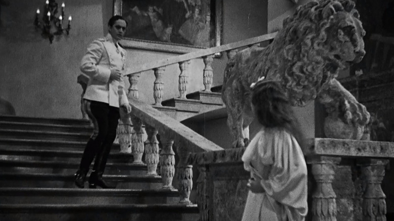 Fredric March descending stairs