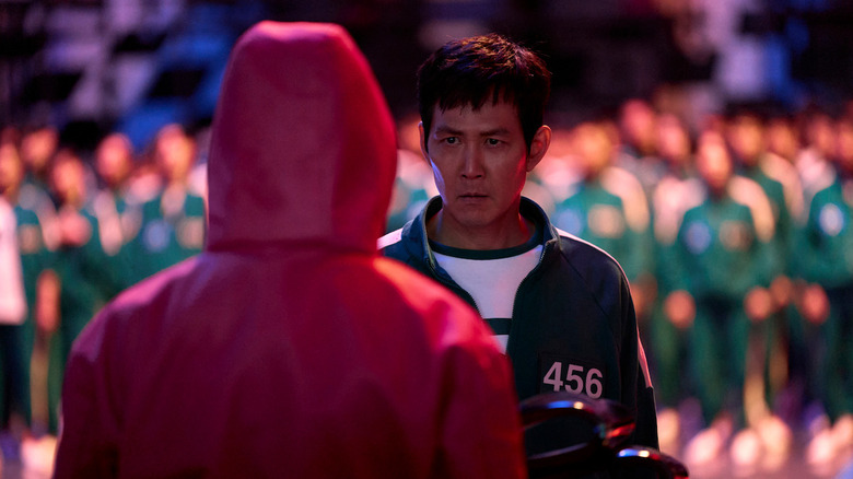 Seong Gi-hun (Lee Jung-jae) glares at a guard in Squid Game