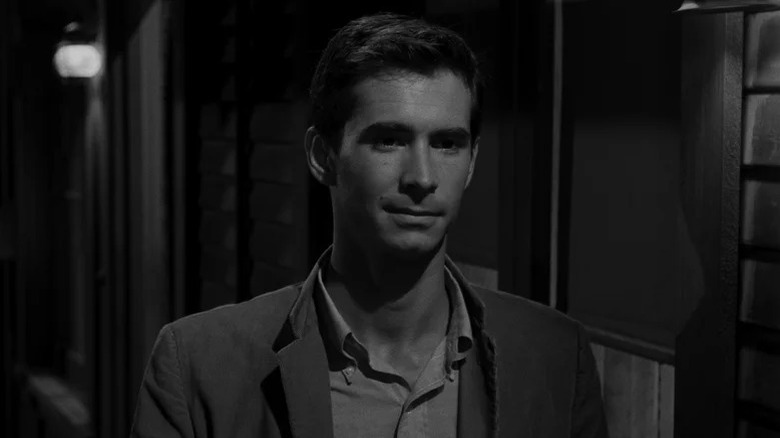 Anthony Stewart as Norman Bates with a small smile in Psycho.