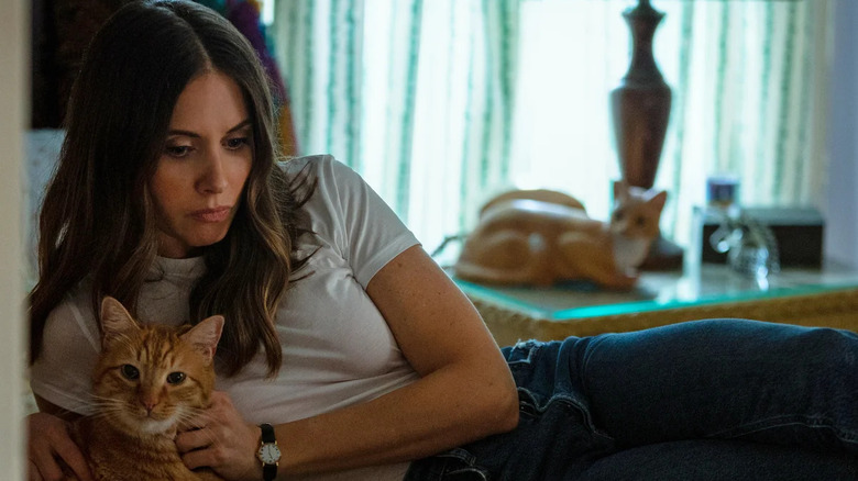 Alison Brie as Ally laying in bed with a cat in Somebody I Used To Know