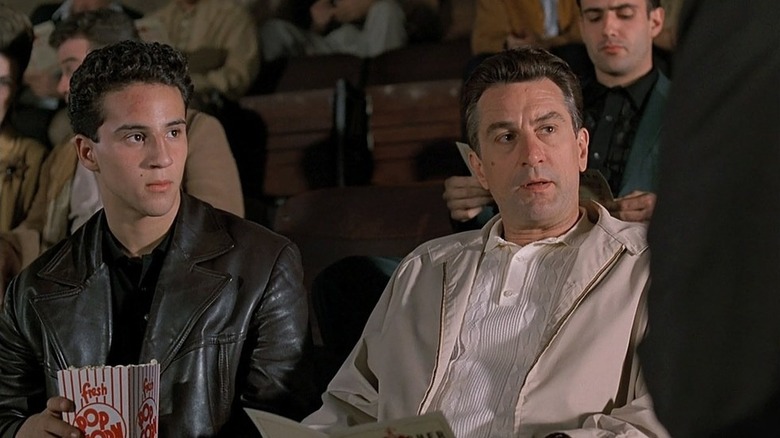 Calogero (Lillo Brancato, Jr.) sits next to Lorenzo (Robert De Niro) in a theater in A Bronx Tale