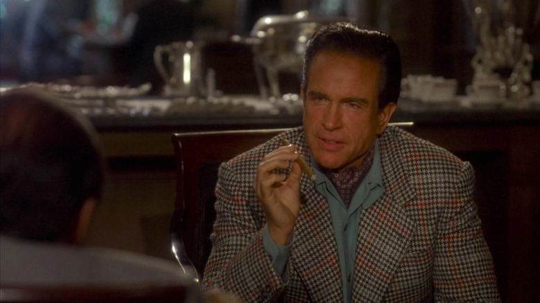 Bugsy Siegel (Warren Beatty) smokes a cigar in Bugsy