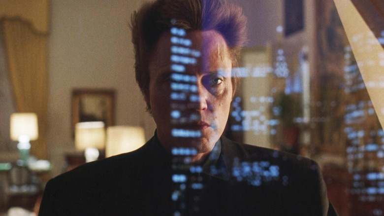 Frank White (Christopher Walken) stares at city lights outside a window in King of New York