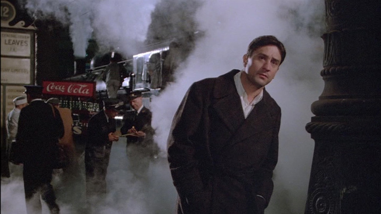 Noodles Aaronson (Robert De Niro) stands in a smoky train station in Once Upon a Time in America