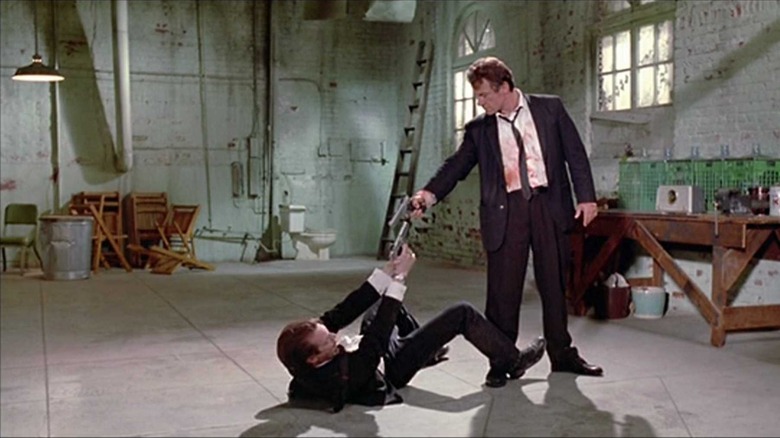 Mr. Pink (Steve Buscemi) and Mr. White (Harvey Keitel) point guns at each other in Reservoir Dogs