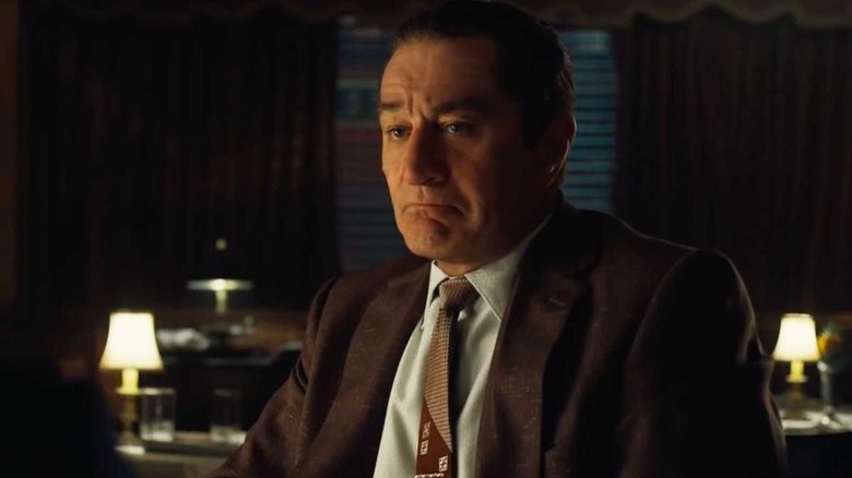 Frank Sheeran (Robert De Niro) sits in a darkened lounge in The Irishman