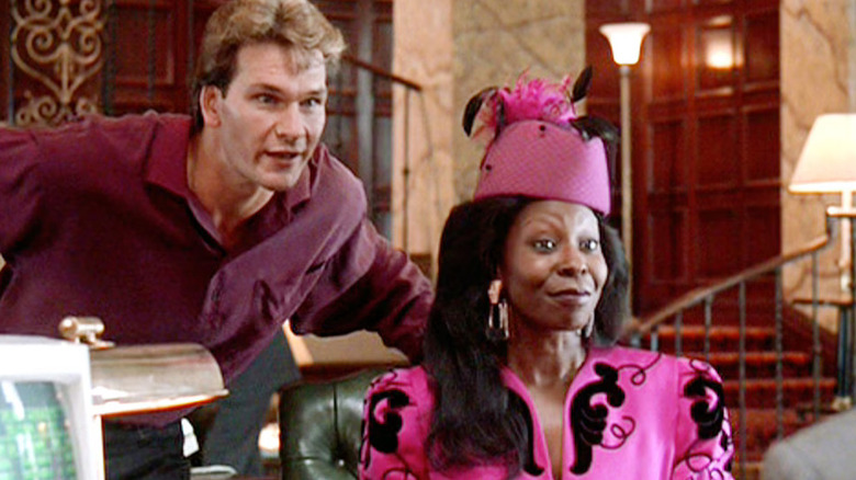 Patrick Swayze as Sam stands over the shoulder of Whoopi Goldberg as Oda Mae Brown in Ghost