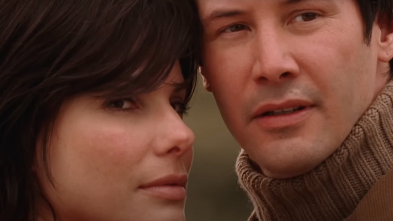 Sandra Bullock as Kate Forster stands next to Keanu Reeves as Alex Wyler in The Lake House