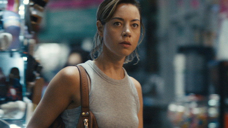 Aubrey Plaza as Emily,walking through the street in Emily the Criminal