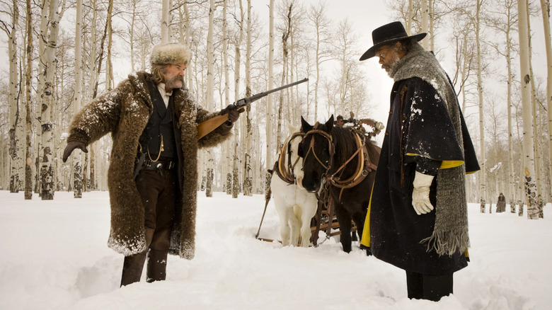 Kurt Russell and Samuel L. Jackson as The Hangman and Marquis, standing off in the forest in The Hateful Eight