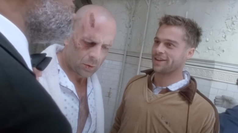 Bruce Willis as James Cole stands next to Brad Pitt as Jeffrey Goines in 12 Monkeys