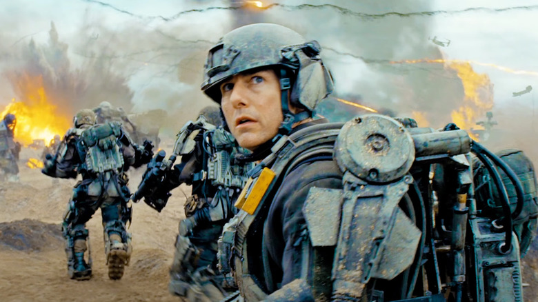 Tom Cruise as William Cage looks terrified on a battlefield in Edge of Tomorrow