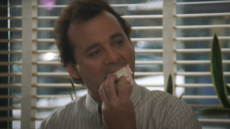 Bill Murray as Phil Connors chows down on some cake in Groundhog Day