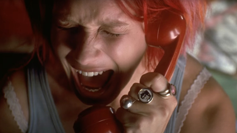 Franka Potente as Lola screams into a red phone in Run Lola Run