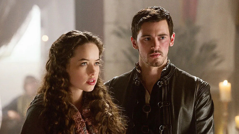 Lola (Anna Popplewell) stands next to a bruised Frederick (Jim Watson) on Reign