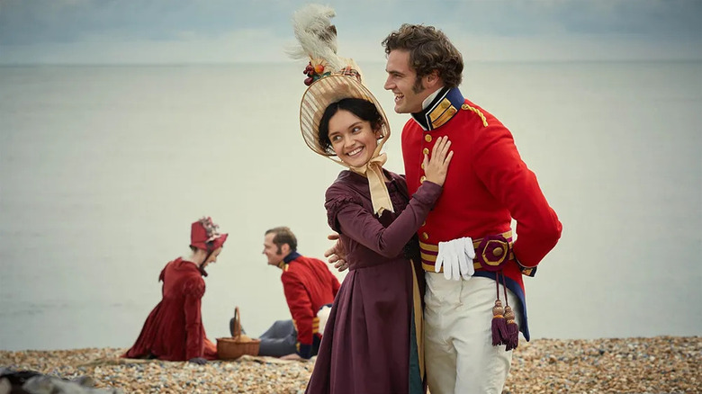 Becky Sharp (Olivia Cooke) smiles touching the chest of Rawdon Crawley (Tom Bateman) on Vanity Fair