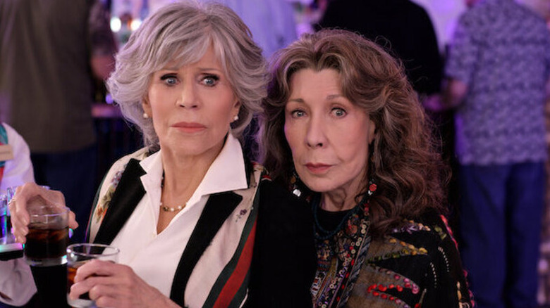 Frankie (Lily Tomlin) holds a confused Grace (Jane Fonda) at a party in Grace and Frankie