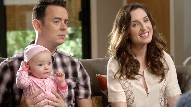 Gregory (Colin Hanks) and Jennifer (Zoe Lister-Jones) hold their daughter in Life in Pieces