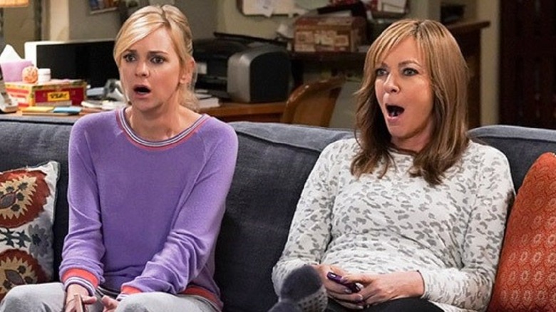 Christy (Anna Faris) and Bonnie (Allison Janney) sit shocked on the couch in Mom