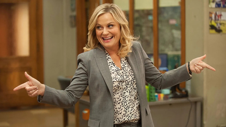 Leslie Knope (Amy Poehler) happily points with finger guns in Parks and Recreation