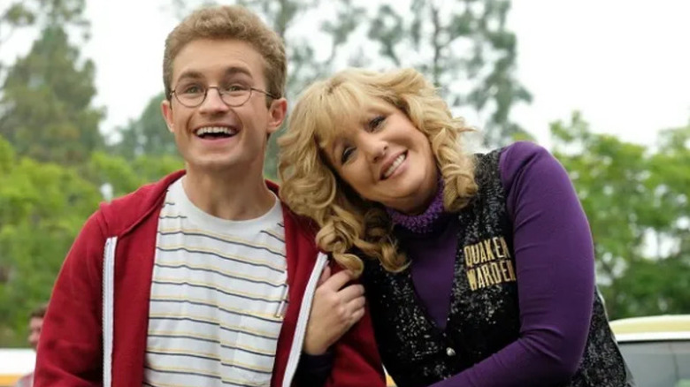 Beverly (Wendi McLendon-Covey) clings to Adam's arm in The Goldbergs