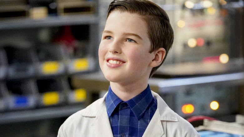 Sheldon Cooper (Ian Armitage) smiles wearing a lab coat in Young Sheldon