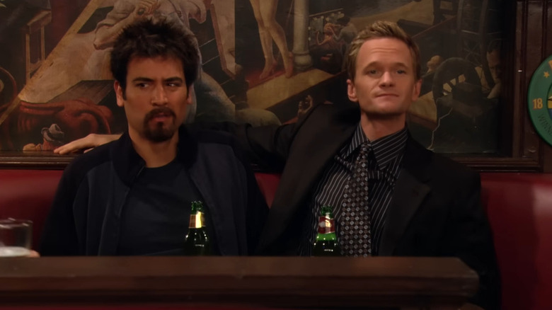 Barney (Neil Patrick Harris) sitting with Ted (Josh Radnor) on How I Met Your Mother