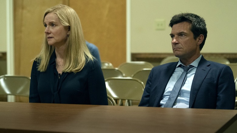 Laura Linney as Wendy Byrde and Jason Bateman as Marty Byrde sitting at a table in Ozark