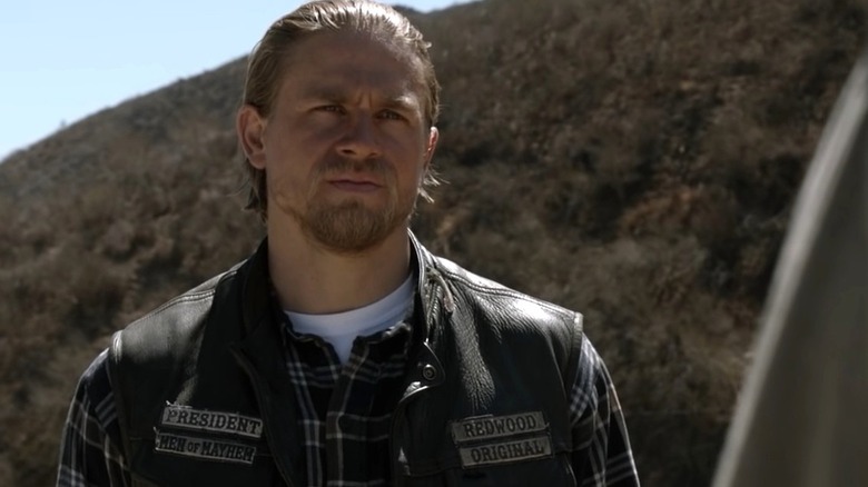 Charlie Hunnam as Jax Teller wearing his SAMCRO jacket and staring in Sons of Anarchy