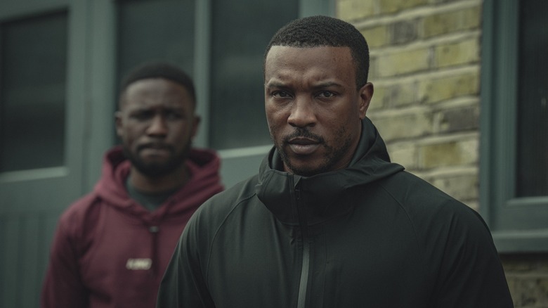 Joshua Blisset as Kieron looking at Ashley Walters as Dushane in Top Boy