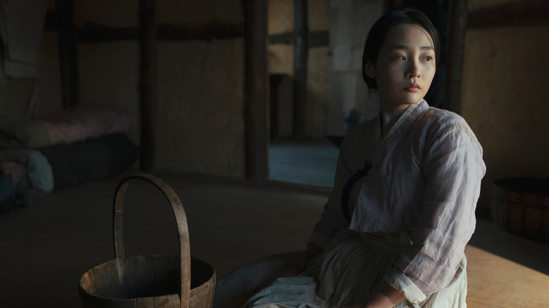 Kim Min-ha as Sunja sitting on floor in Pachinko