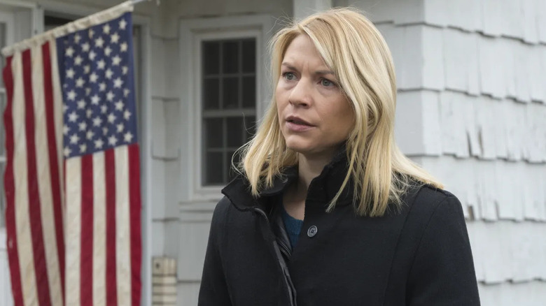 Carrie Mathison (Claire Danes) stands next to an American flag on Homeland