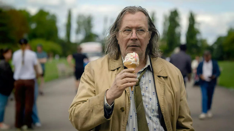 Jackson Lamb (Gary Oldman) eats ice cream in a park in Slow Horses